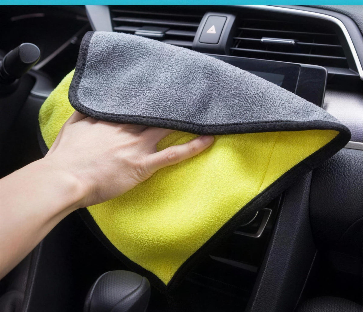 The two-sided microfibre towel wiping down a dashboard