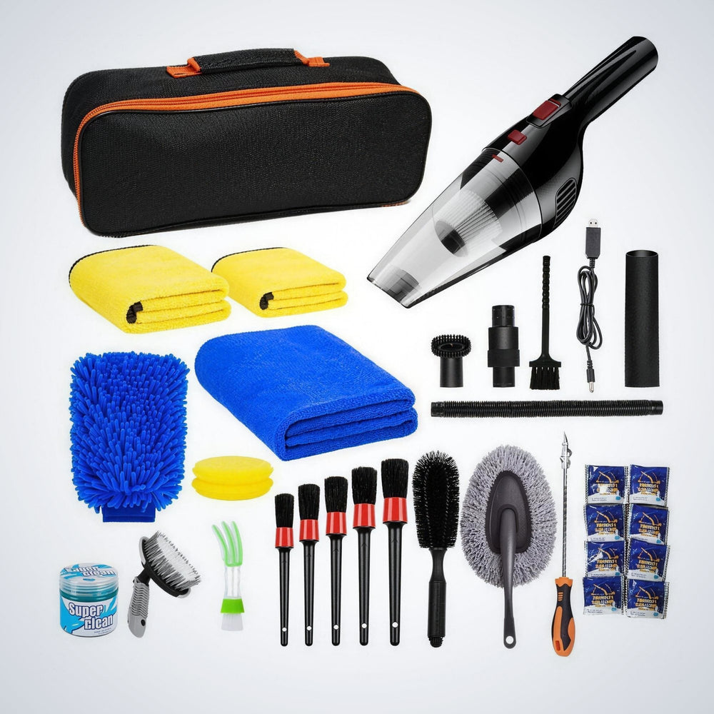 Everything in the kit laid out: cordless vacuum, attachments, detailing brushes, wash mitt, microfibre towels, duster, cleaning gel and carry bag